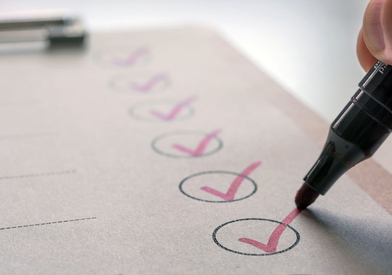 Red pen shown completing the final tick in a column of ticked circles.