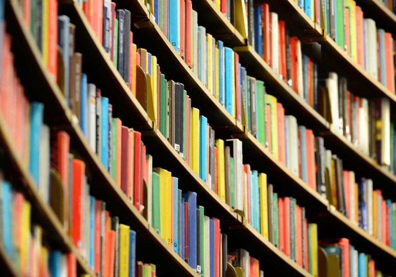 Curved shelves of colourful books.